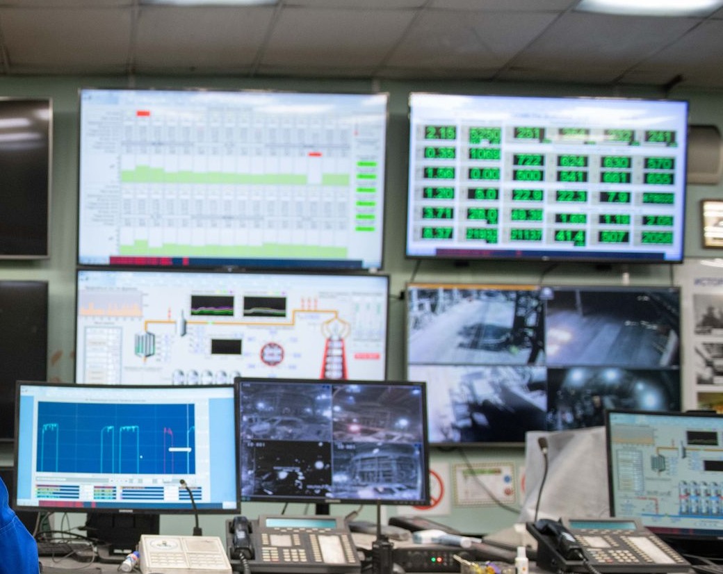 Control-room screens showing network diagrams and system study data